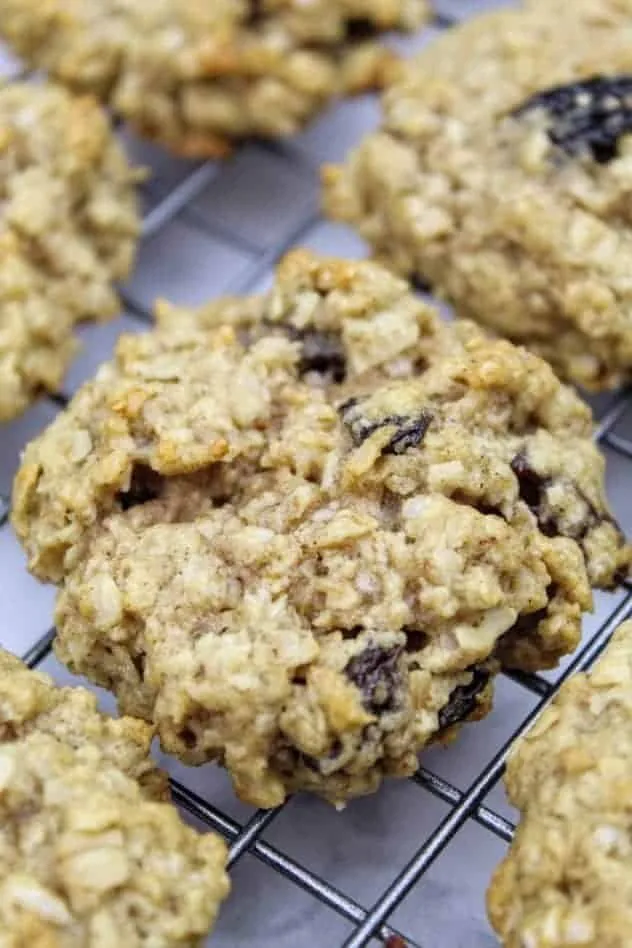 Vegan Oatmeal Raisin Cookies Process Step 5 Vegan oatmeal raisin cookies sitting on a wire rack to cool after baking.