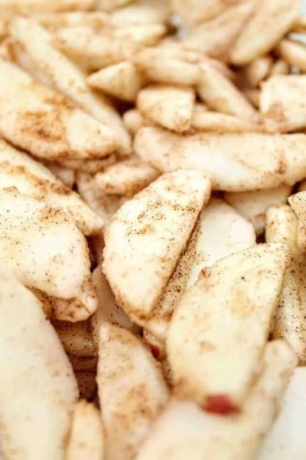 Vegan Gluten-Free Apple Crisp Process Step 2 A close-up of apple slices coated with gluten-free flour and apple pie spice.